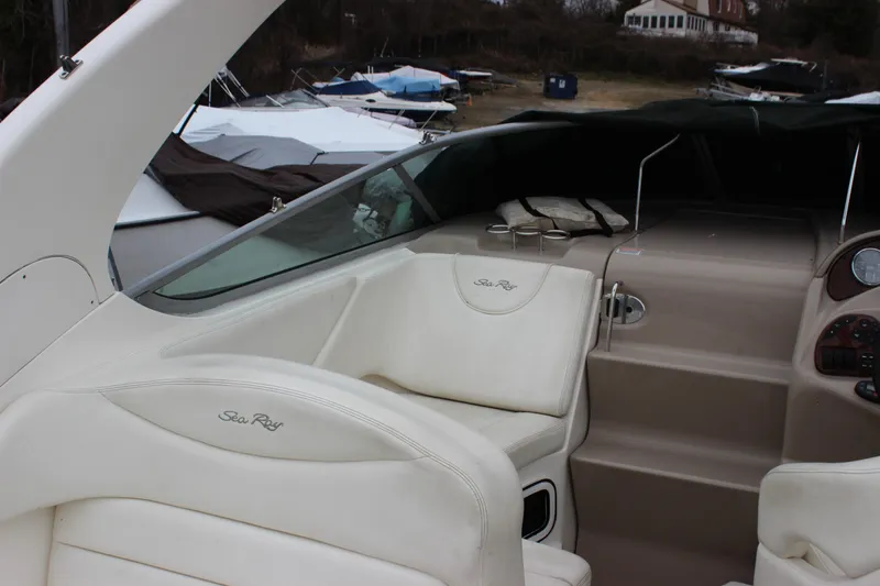 Slide: The Image of 2005 Sea Ray Sundancer 280 interior with white seating and dashboard view. - 7