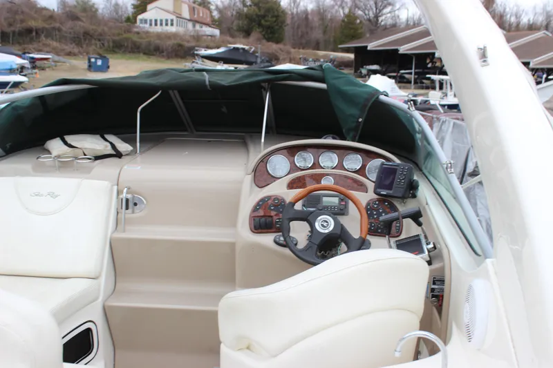 Slide: The Image of 2005 Sea Ray Sundancer 280 cockpit with steering wheel and navigation instruments. - 9