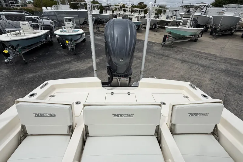 Slide: The Image of 2023 Pathfinder 2600 TRS boat with outboard motor, surrounded by other boats in a lot. - 10