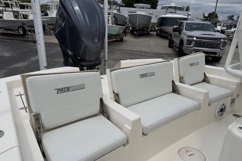 Slide: The Image of 2023 Pathfinder 2600 TRS boat with white seating and Yamaha outboard motor. - 11