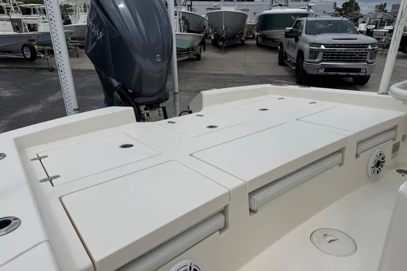 Slide: The Image of 2023 Pathfinder 2600 TRS boat with outboard motor, docked near trucks and other boats. - 12