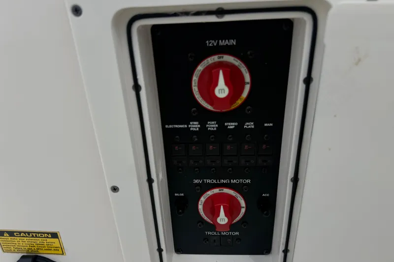Slide: The Image of Control panel of a 2023 Pathfinder 2600 TRS boat with switches and dials. - 13