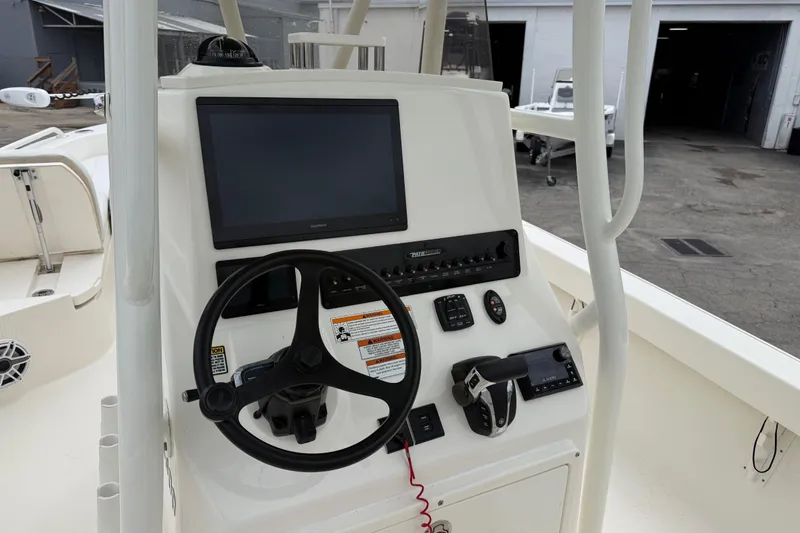 Slide: The Image of 2023 Pathfinder 2600 TRS boat console with steering wheel and navigation controls. - 16