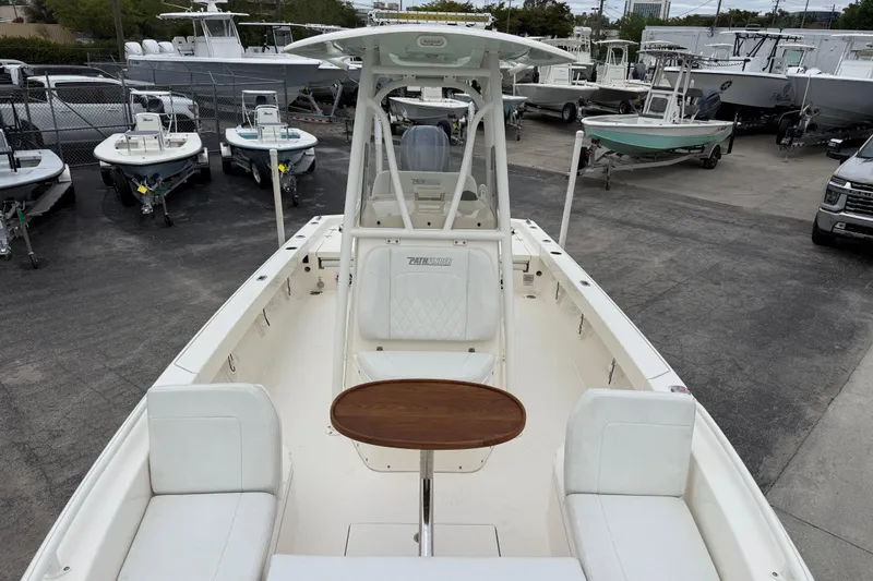 Slide: The Image of 2023 Pathfinder 2600 TRS boat with seating and table, displayed in a dealership lot. - 19