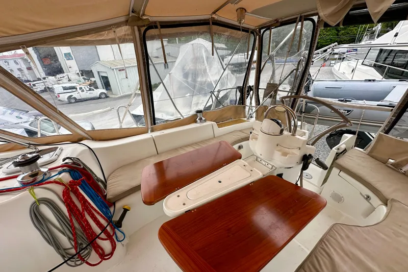 Slide: The Image of Cockpit of 2005 Beneteau Oceanis Clipper 423 sailboat with wooden tables and steering wheel. - 12