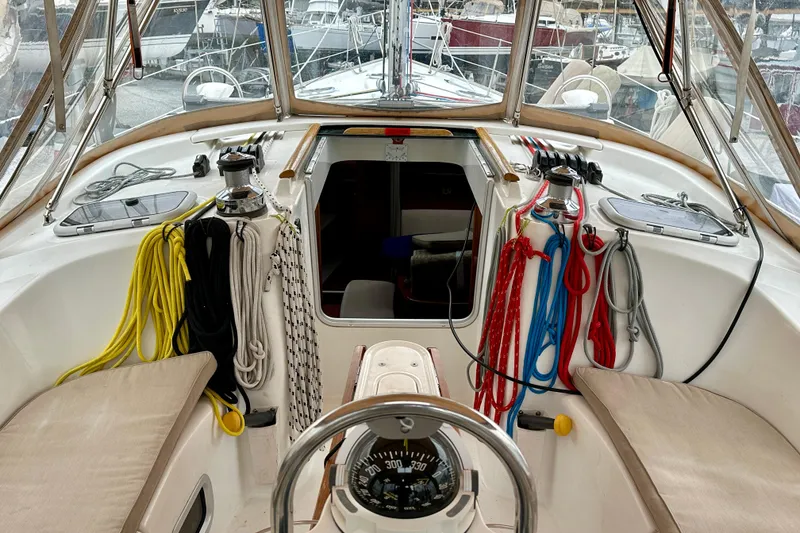 Slide: The Image of Cockpit of 2005 Beneteau Oceanis Clipper 423 sailboat with colorful ropes and navigation instruments. - 13