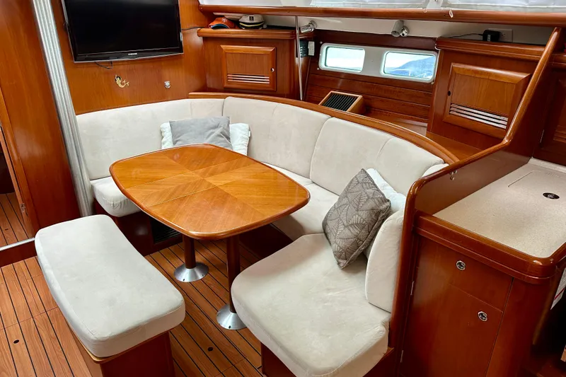 Slide: The Image of Interior of 2005 Beneteau Oceanis Clipper 423 yacht with cozy seating and wooden table. - 17
