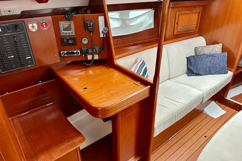 Slide: The Image of Interior of 2005 Beneteau Oceanis Clipper 423 with navigation station and cozy seating area. - 19