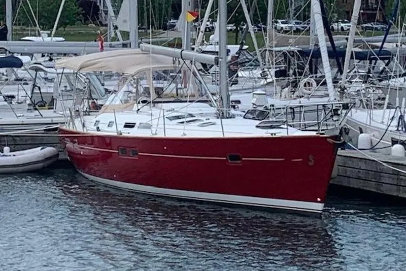 Slide: The Image of Red 2005 Beneteau Oceanis Clipper 423 sailboat docked in marina. - 2