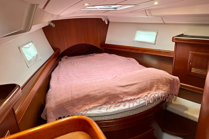 Slide: The Image of Cozy cabin interior of 2005 Beneteau Oceanis Clipper 423 sailboat with pink bedding. - 22