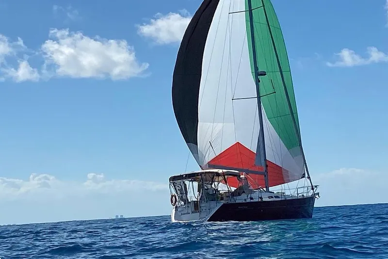 Slide: The Image of Sailing yacht Beneteau Oceanis Clipper 423, 2005 model, with colorful sails on open sea. - 4