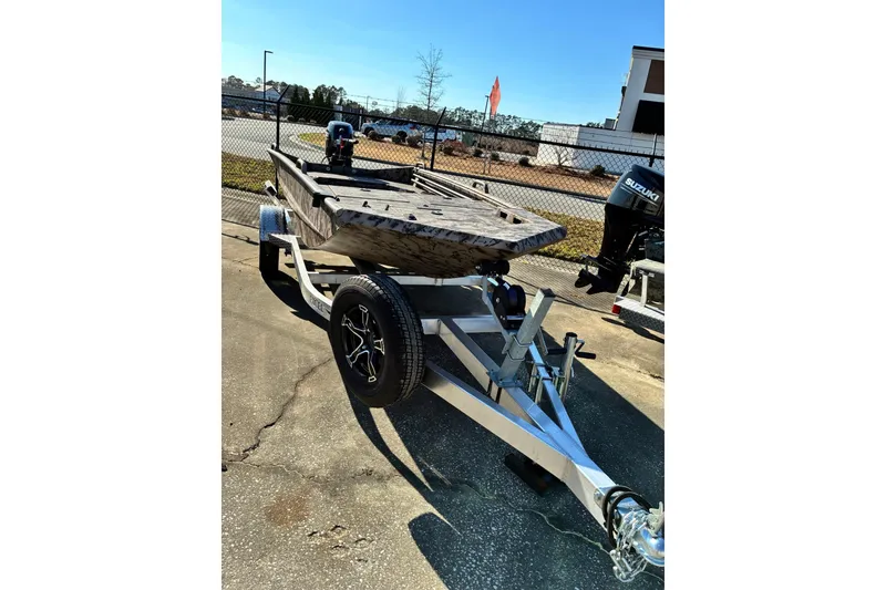 Slide: The Image of 2025 Excel Eclipse boat on trailer, parked outdoors under clear blue sky. - 2