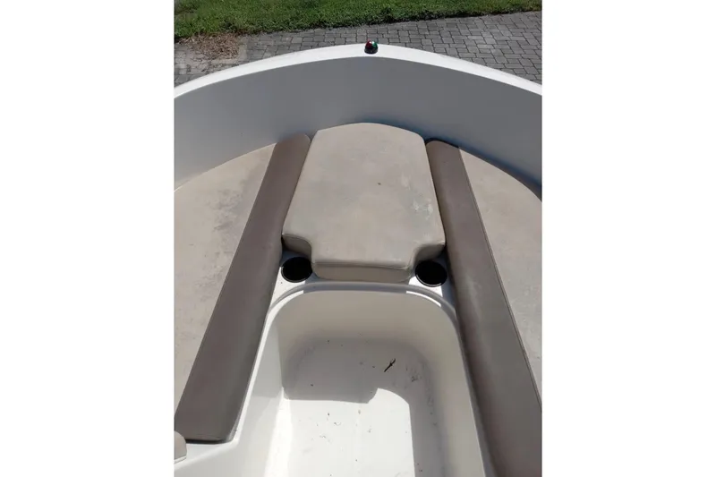 Slide: The Image of 2017 Bayliner Element E16 boat interior with cushioned seating and cup holders. - 10
