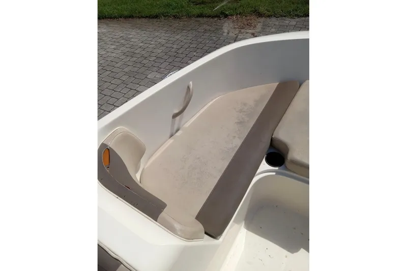 Slide: The Image of 2017 Bayliner Element E16 boat interior with beige seating and cup holder. - 11
