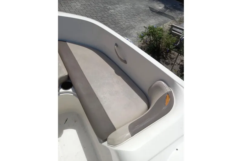 Slide: The Image of 2017 Bayliner Element E16 boat interior with beige seating and cup holder. - 12