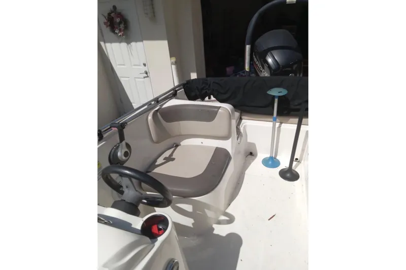 Slide: The Image of 2017 Bayliner Element E16 boat interior with steering wheel and seating. - 14