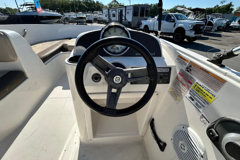 Slide: The Image of 2017 Bayliner Element E16 boat dashboard with steering wheel and control panel. - 15