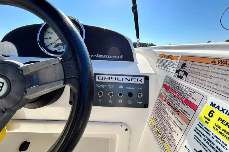 Slide: The Image of 2017 Bayliner Element E16 dashboard with steering wheel and control panel. - 17