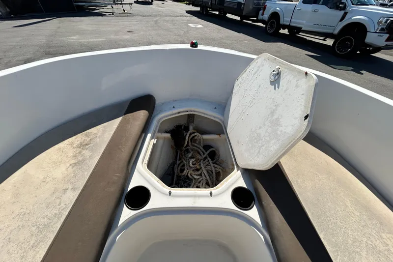 Slide: The Image of 2017 Bayliner Element E16 boat interior with open storage compartment and ropes. - 24
