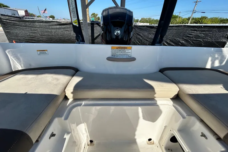 Slide: The Image of 2017 Bayliner Element E16 boat interior with cushioned seating and motor view. - 33