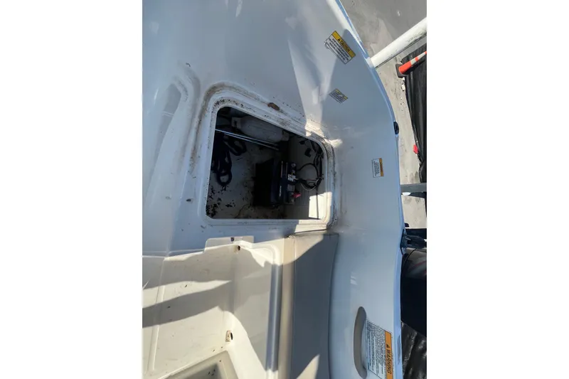 Slide: The Image of 2017 Bayliner Element E16 boat storage compartment with visible battery and wiring. - 39