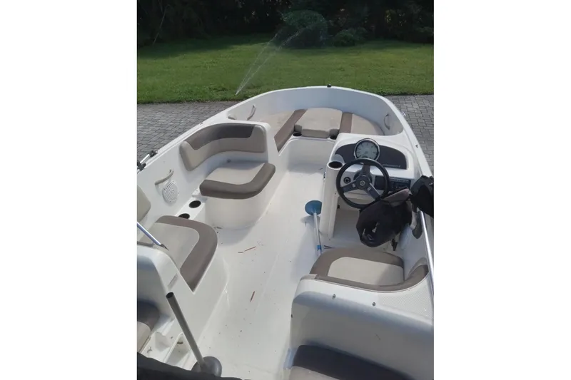Slide: The Image of 2017 Bayliner Element E16 boat interior with seating and steering wheel. - 4