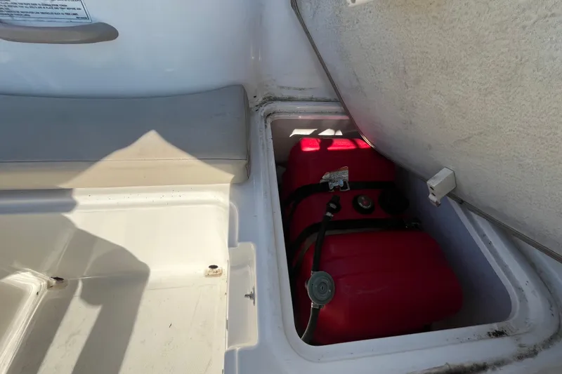Slide: The Image of 2017 Bayliner Element E16 boat storage compartment with red fuel tank. - 42