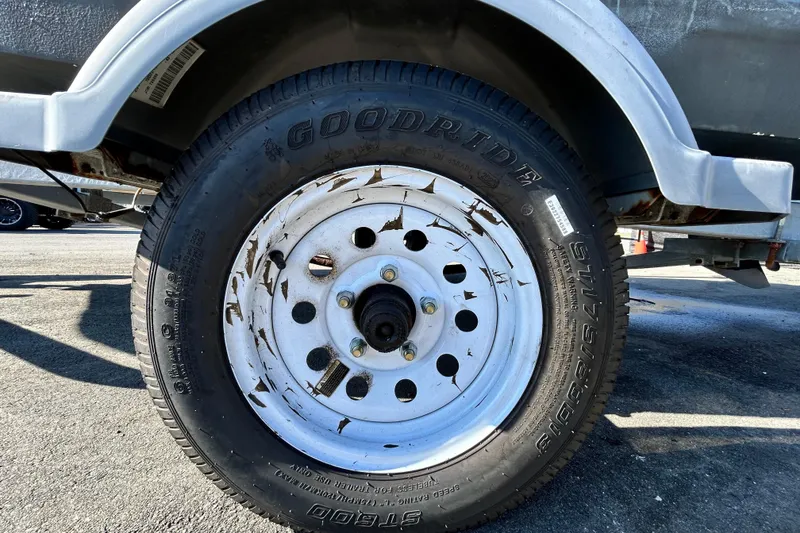 Slide: The Image of Close-up of a 2017 Bayliner Element E16 trailer tire with visible rust and wear. - 46