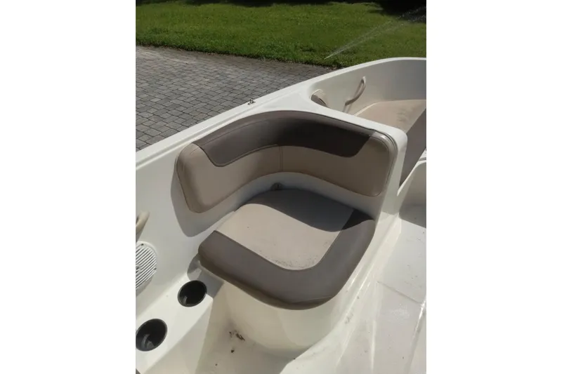 Slide: The Image of 2017 Bayliner Element E16 boat interior with cushioned seating and cup holders. - 5