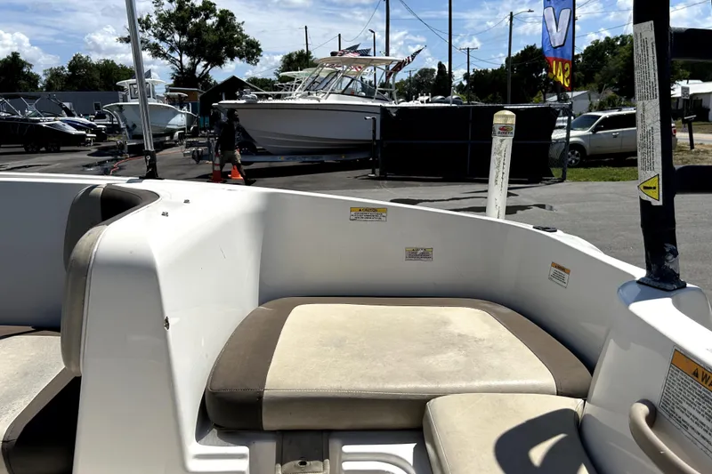 Slide: The Image of 2017 Bayliner Element E16 boat interior with seating, parked in a marina. - 50