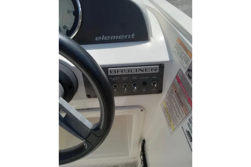 Slide: The Image of 2017 Bayliner Element E16 dashboard with steering wheel and control panel. - 8