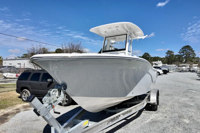 Slide: The Image of 2026 Sea Fox 248 Commander boat on trailer under clear blue sky. - 2