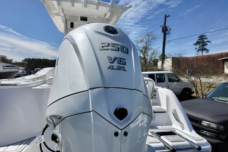 Slide: The Image of 2026 Sea Fox 248 Commander with Yamaha 250 V6 outboard engine, parked outdoors. - 4