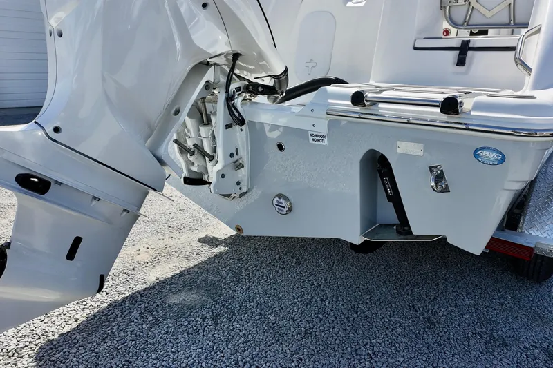 Slide: The Image of 2026 Sea Fox 248 Commander boat engine and transom detail on gravel surface. - 5