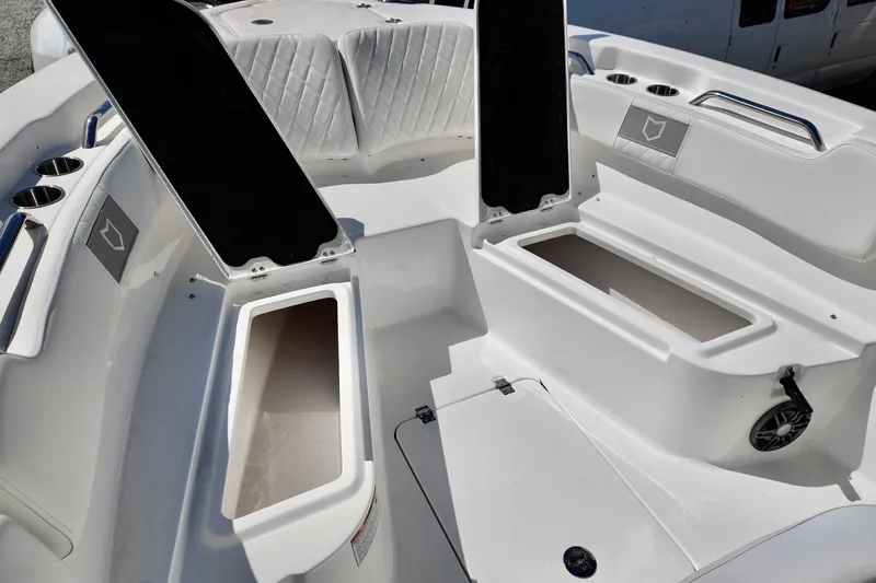 Slide: The Image of 2026 Sea Fox 248 Commander boat interior with open storage compartments and cup holders. - 9