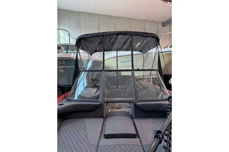Slide: The Image of 2026 Starweld 18 SXT boat with canopy in showroom setting. - 11