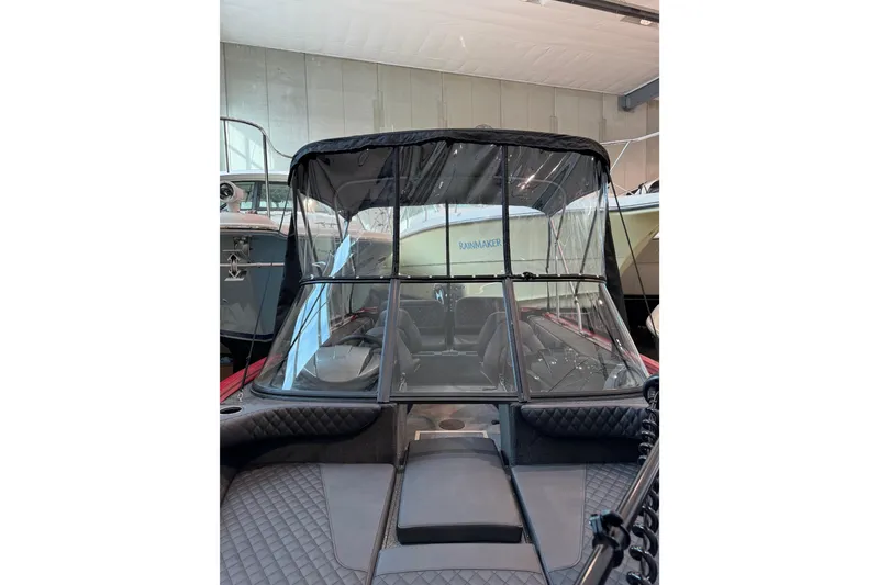 Slide: The Image of 2026 Starweld 18 SXT boat with protective canopy in showroom setting. - 13