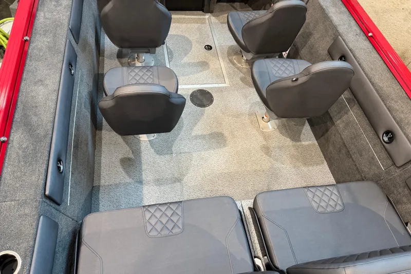 Slide: The Image of 2026 Starweld 18 SXT boat interior with gray seating and red accents. - 18