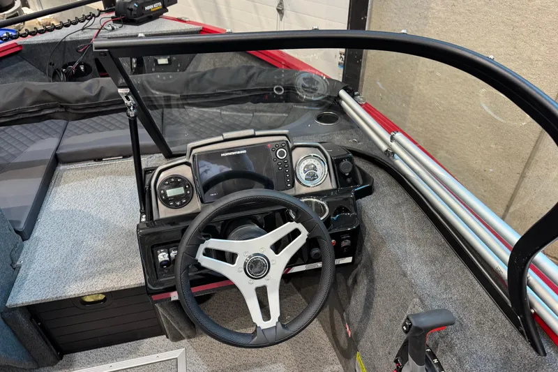Slide: The Image of 2026 Starweld 18 SXT boat dashboard with steering wheel and navigation controls. - 22