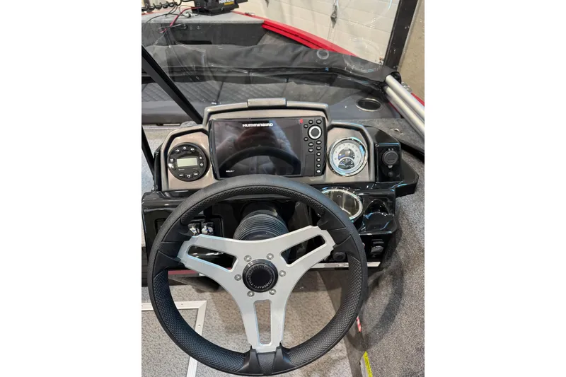 Slide: The Image of 2026 Starweld 18 SXT boat dashboard with steering wheel and navigation controls. - 23