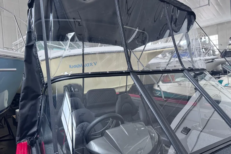 Slide: The Image of 2026 Starweld 18 SXT boat with protective canopy in a showroom. - 28