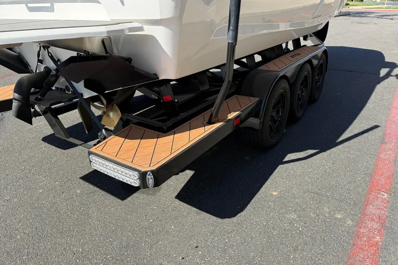 Slide: The Image of Trailer for 2025 MB B52 25 Alpha boat with triple axles and wooden deck. - 11