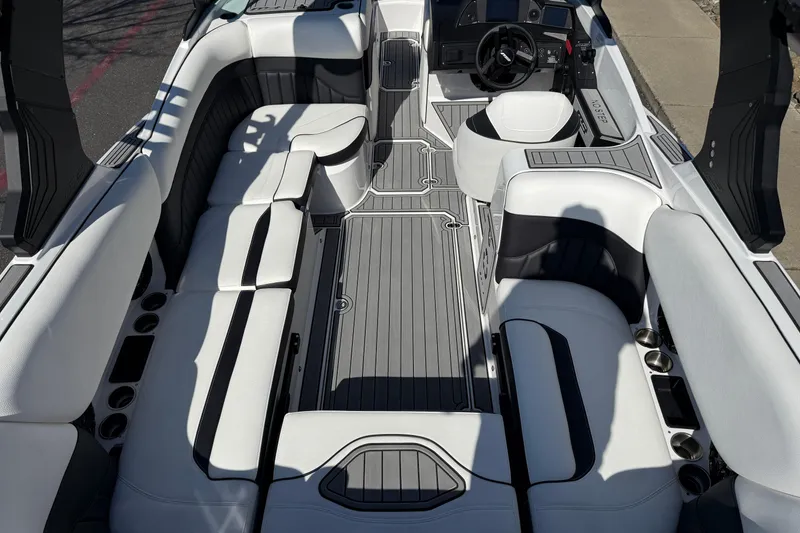 Slide: The Image of 2025 MB B52 25 Alpha boat interior with sleek seating and modern dashboard design. - 17
