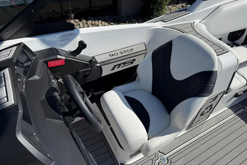Slide: The Image of 2025 MB B52 25 Alpha boat cockpit with steering wheel and cushioned seat. - 19