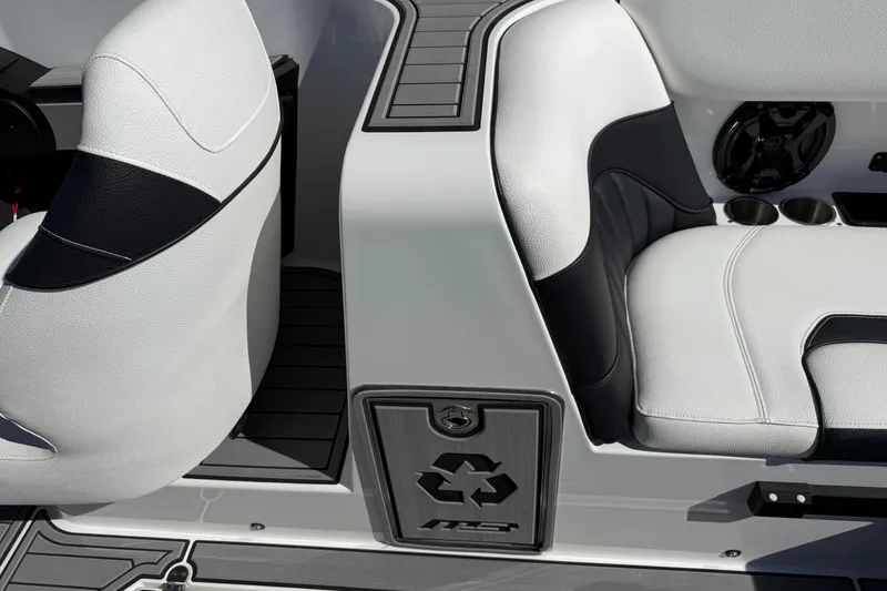 Slide: The Image of 2025 MB B52 25 Alpha boat interior with white and black seating, cup holders, and speaker. - 20