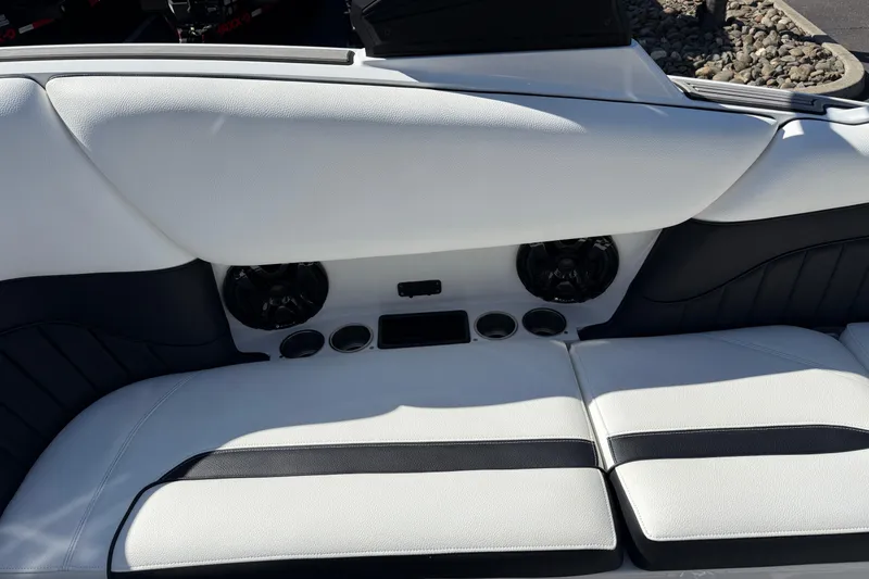 Slide: The Image of 2025 MB B52 25 Alpha boat interior with white seating and built-in speakers. - 26