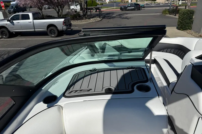 Slide: The Image of 2025 MB B52 25 Alpha boat interior with sleek seating and windshield design. - 29