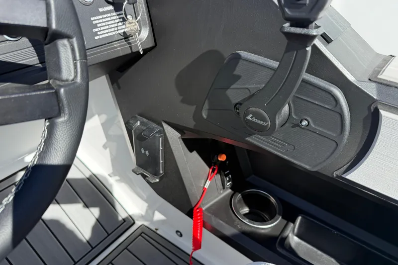 Slide: The Image of 2025 MB B52 25 Alpha boat dashboard with steering wheel and control panel. - 38