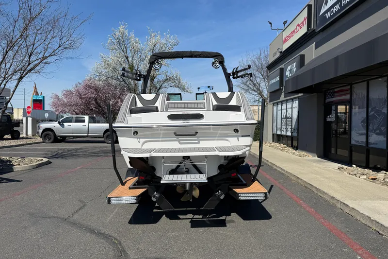Slide: The Image of 2025 MB B52 25 Alpha boat parked outside dealership, showcasing rear design and features. - 4