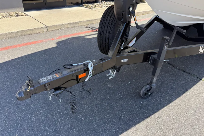 Slide: The Image of Trailer hitch of MB B52 25 Alpha 2025 boat on pavement. - 8